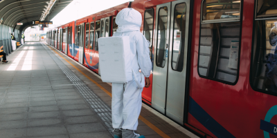 Freelancer in astronaut costume waits for subway doors to open